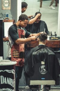 Customer using smartphone to book barbershop appointment showing mobile-first online booking experience